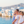 familie met vader moeder en twee meisjes kijken uit over zee aan griekse kust met witte huisjes