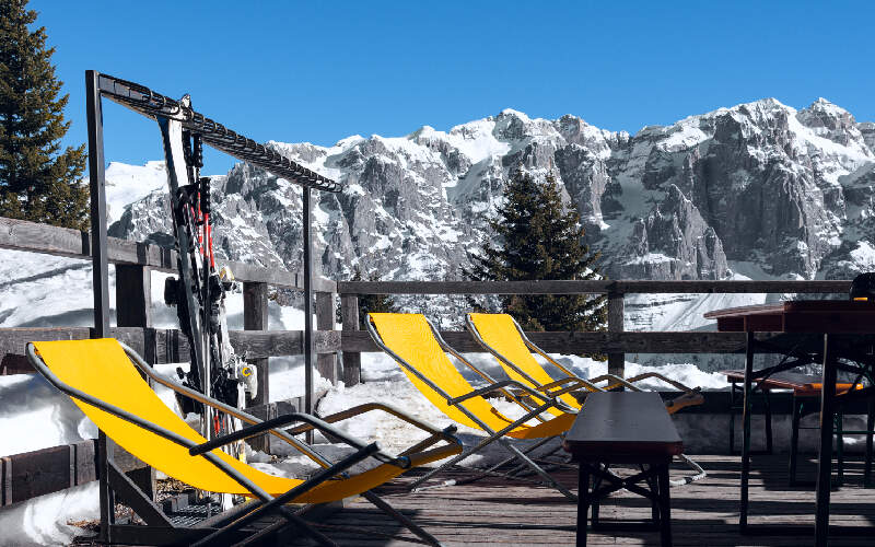 gele ligbedjes op zonneterras in skigebied in oostenrijk