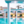 zwembad omringd met blauwe parasols, ligbedjes met pilaren met spots aan een all inclusive hotel